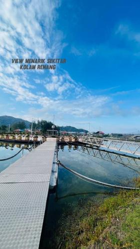 a dock with a boat in the water at D'Marina 2 HOMESTAY LUMUT MANJUNG in Lumut