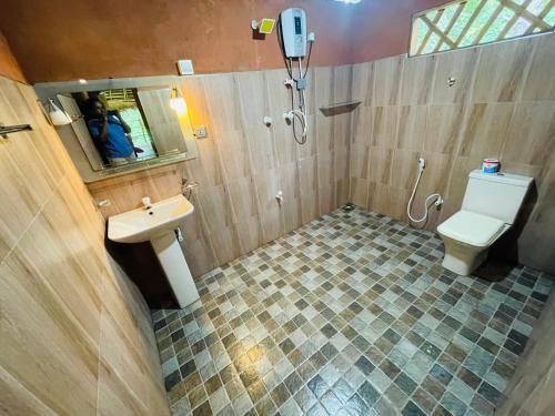 a bathroom with a toilet and a sink at LakeSide Cabana Tissamaharama in Tissamaharama