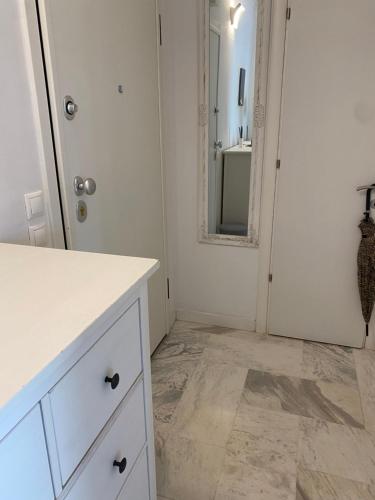 a white bathroom with a sink and a mirror at Lovely place in Perea in Perea