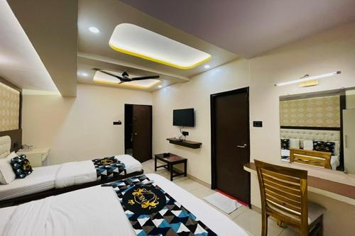 a room with a bed and a chair in it at Hotel Neelkiran in Navi Mumbai