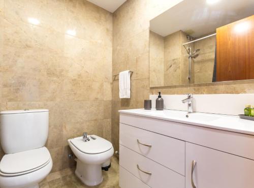 a bathroom with a toilet and a sink at Picasso Suites in Barcelona