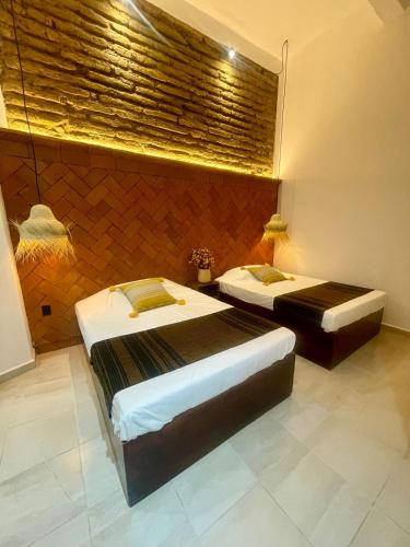 a bedroom with two beds in a room at Casa Sofi Oaxaca in Oaxaca City