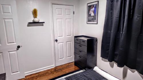 a room with a door and a dresser with a black curtain at Luxury duplex unit in Nashville Unit A in Nashville