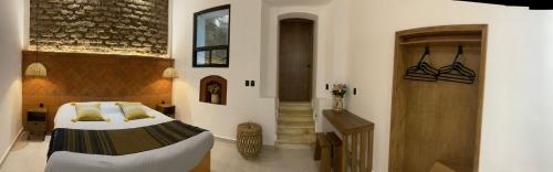 a bedroom with a large bed and a staircase at Casa Sofi Oaxaca in Oaxaca City