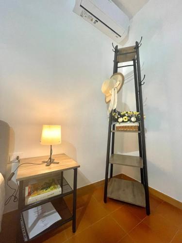 a room with a ladder and a lamp and a table at DAL ZARO HOME in Scandolara Ravara