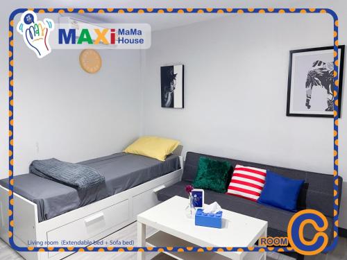 a room with a bed and a couch and a table at MAXi MaMa Room in Bangkok