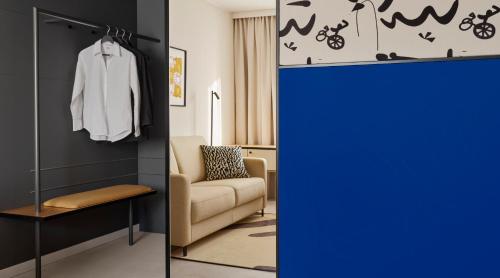 a room with a blue door and a room with a chair at Original Sokos Hotel Royal in Vaasa