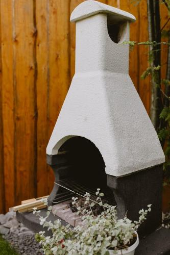 a outdoor pizza oven sitting next to a wooden fence at Na Wierchach in Wisła