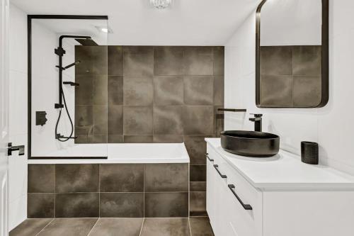 a bathroom with a sink and a shower at La Grande Apartments in Gold Coast
