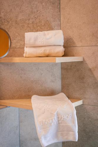 a pair of wooden shelves with towels on them at Hotel Trattlerhof in Bad Kleinkirchheim