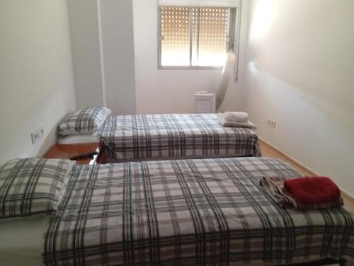 Katil atau katil-katil dalam bilik di Apartamentos Torresmar