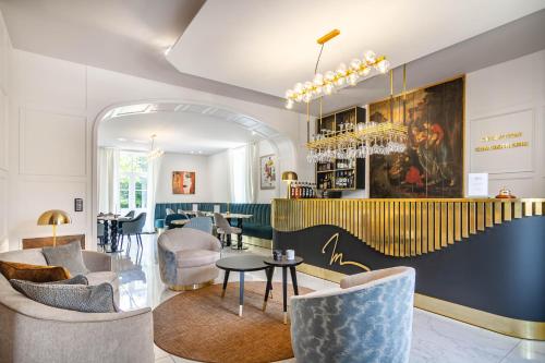a lobby with chairs and tables and a bar at Château de Maraval in Cénac-et-Saint-Julien