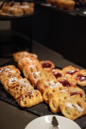 a bunch of pastries sitting on top of a table at Skostredet Hotel in Bergen