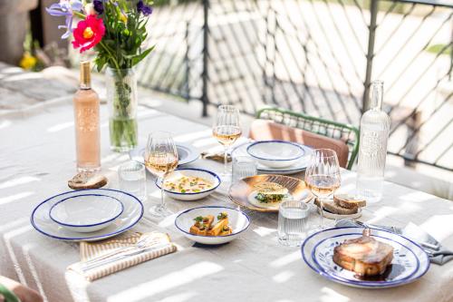 a table with plates of food and glasses of wine at Ultimate Provence Hotel & Spa in La Garde-Freinet