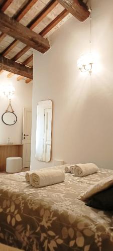 a bedroom with two large beds with a mirror at Locanda la Rocca Residenza d'Epoca in Fossombrone