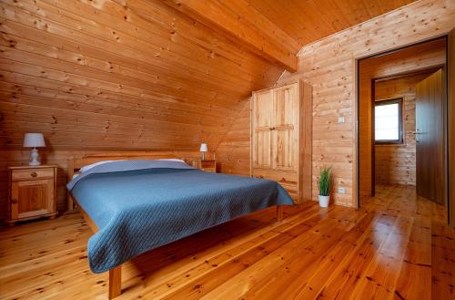 a bedroom with a bed in a wooden cabin at Raj nad Morzem in Bobolin
