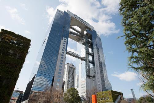 a tall building with an arch in front of it at Hotel Osaka Castle in Osaka