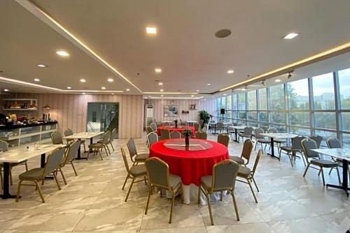 a dining room with tables and chairs and windows at Amethyst Boutique Hotel Cebu powered by Cocotel in Cebu City
