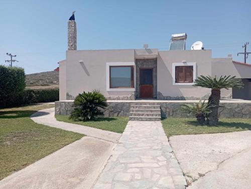 a house with a stone walkway in front of it at Katavias House in Kattavía