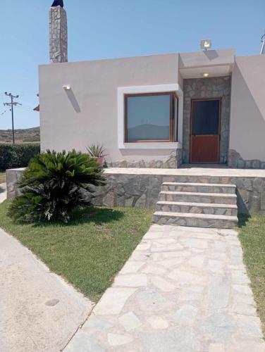 a house with a stone walkway in front of it at Katavias House in Kattavía