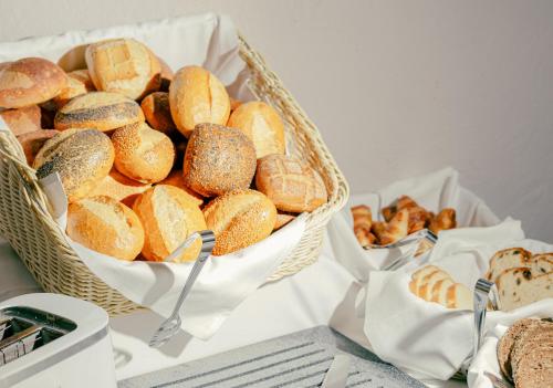 two baskets filled with breads and pastries on a table at Romantik Hotel Walhalla in Osnabrück