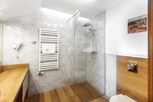 a bathroom with a shower with a glass door at SOLAVO HOME&TRAVEL in Solec-Zdrój