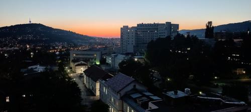 a view of a city at sunset with buildings at Apartment Mia in Sarajevo