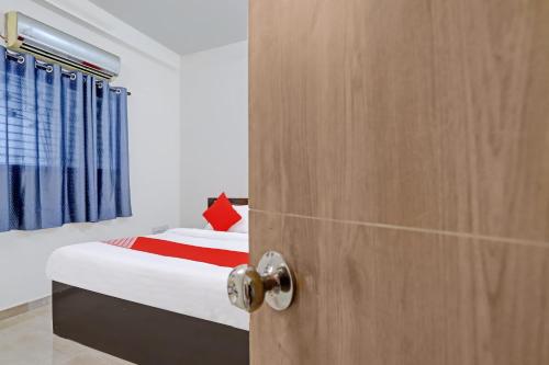 a door leading into a bedroom with a bed at Hotel O Casino in Nagpur