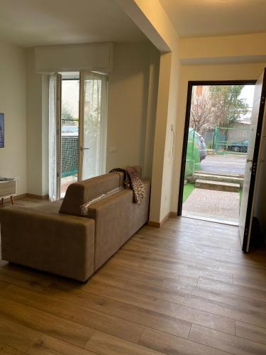 a living room with a couch and a sliding glass door at Casa Doni in Pesaro