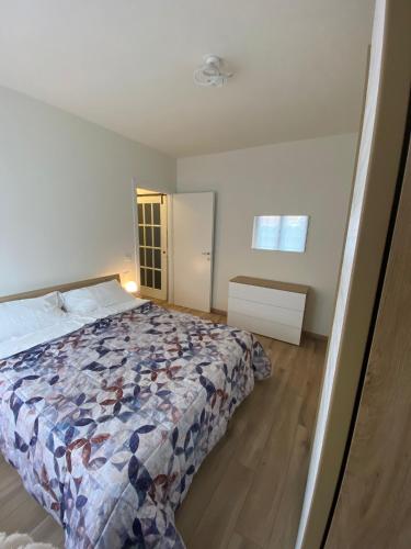 a bedroom with a bed with a quilt on it at Casa Doni in Pesaro