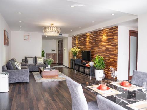 a living room with a couch and a table at Viet Vuong Building Ha Noi Capital in Hanoi
