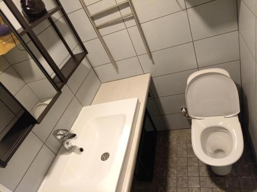 a bathroom with a toilet and a bath tub at Apartment by the park in Imatra