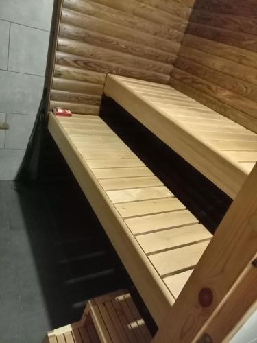 a wooden bed in a room with at Apartment by the park in Imatra
