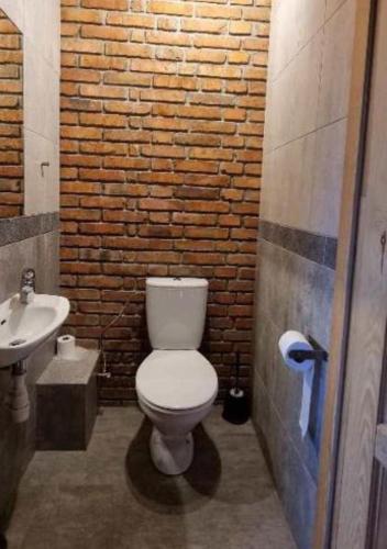 a bathroom with a white toilet and a sink at Ośrodek Wczasowy Na Borach in Korbielów