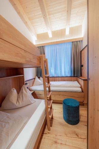 a room with two bunk beds and a window at Ferienwohnungen Karlingerhof am See in Achenkirch