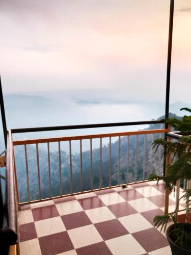 a view from a balcony with a checkered floor at Thakur Apartment in Shimla