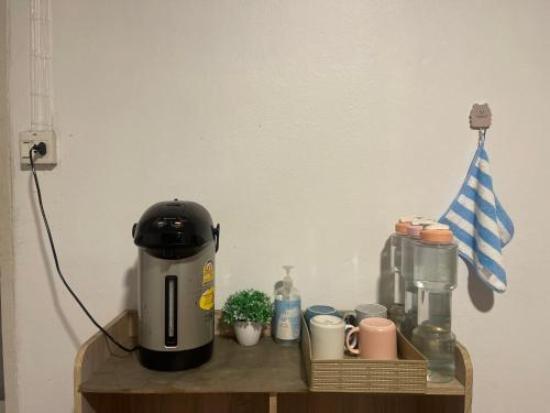 a coffee maker sitting on top of a wooden shelf at airport house in Bangkok