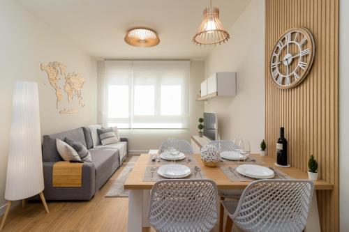 a living room with a couch and a table with chairs at HOME IN CASTRO con PARKING in Castro-Urdiales
