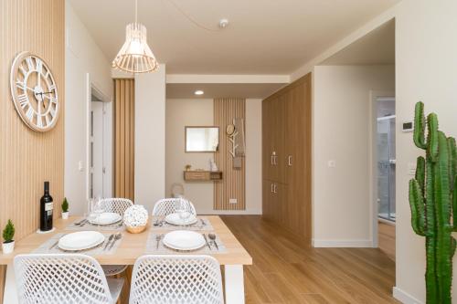 a dining room with a table and chairs and a cactus at HOME IN CASTRO con PARKING in Castro-Urdiales
