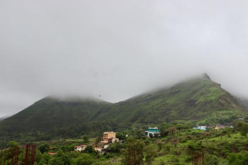 a village on a hillside in the fog at Dolce Villa IGATPURI in Igatpuri