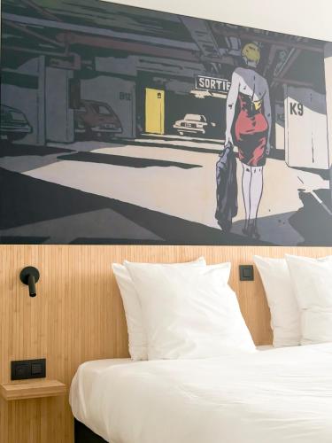 a bedroom with a bed with a painting on the wall at Comic Art Hotel in Ghent