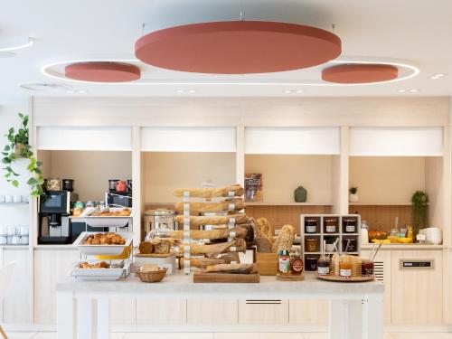 a kitchen with a table with food on it at Novotel Suites Montpellier Antigone in Montpellier