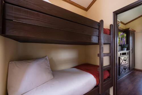 a bedroom with two bunk beds and a mirror at Westgate River Ranch Resort & Rodeo in River Ranch