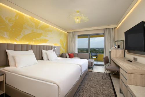 a hotel room with a large bed and a television at Megasaray Resort Side in Side