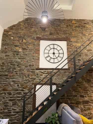 a brick wall with a clock on it at Bien-Être au B in Sart-lez-Spa