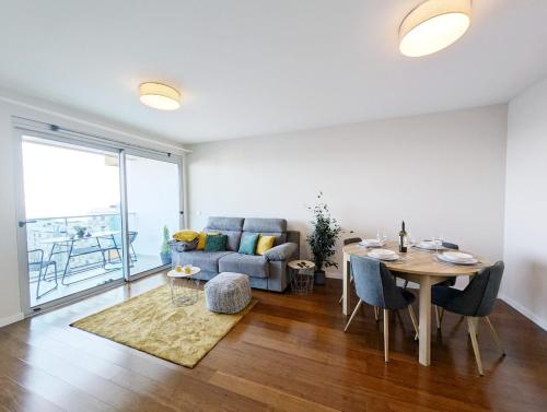 a living room with a table and a couch at Seaview wonder apartment by Anna in Funchal