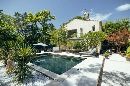 a swimming pool in the backyard of a house at Suite and Spa la Perla Bianca in Grabels