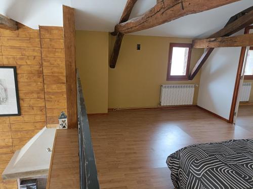 a bedroom with a bed and a wooden floor at LE GRAND CASTILLON - Gîte pêche avec 2 étangs privés, foret et Jacuzzi en option in Castelnau-dʼAuzan