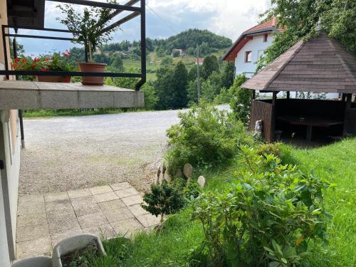 a view of a yard with a house and a garden at Countryside Apartment Agnes in Šentjošt nad Horjulom