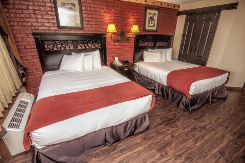 a hotel room with two beds and a brick wall at Westgate River Ranch Resort & Rodeo in River Ranch